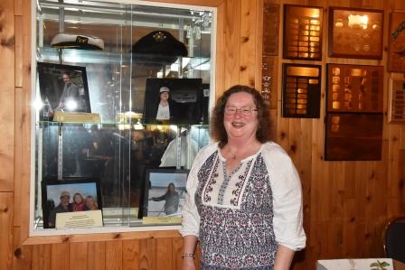 Donna Mehl putting her picture on display